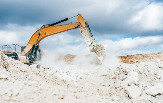 Wheel loader, large bucket with limestone. Construction. Open pit mining quarry